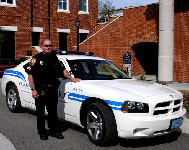 Police Officer with car on campus